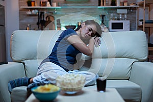 Portrait of young woman asleep on couch