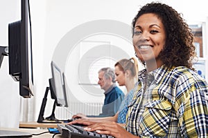 Portrait Of Young Woman Attending Computer Class In Front Of Screen