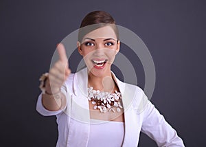 Portrait of young woman with beads showing ok