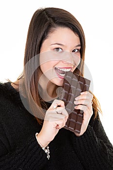 Portrait of young woman bites in chocolate bar