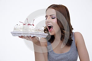 Portrait of a young woman bitting cake