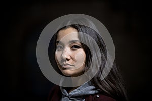 Portrait of young woman on a black background. Looking in the camera