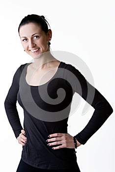 Happy smiling woman standing with arms on hips photo