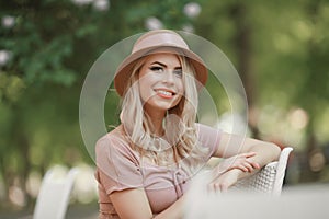 Portrait of a young woman, blonde, glasses, outdoors in the park