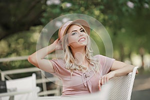 Portrait of a young woman, blonde, glasses, outdoors in the park