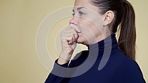 Portrait of young woman blows her nose into napkin, sneezes and coughs, isolated