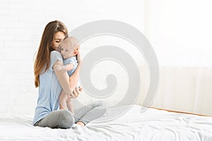 Portrait of young woman bonding with her newborn baby