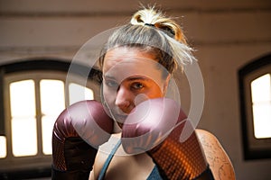 Portrait of young woman at boxing training session