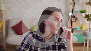 Portrait young woman with a burn scar on her face talking on the phone