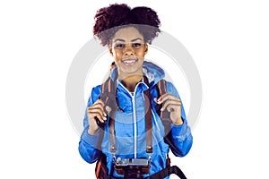 Portrait of a young woman with camera and backpack