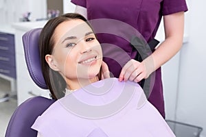 Portrait of young woman before checking up teeth at dentist office