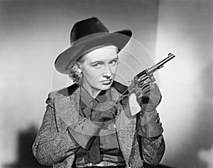 Portrait of a young woman cleaning a handgun