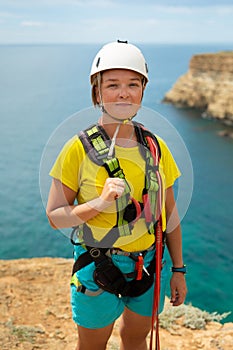 Portrait of a young woman on a cliff before jumping. Extreme sport. Ropejumping.