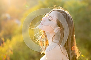 Portrait of a young woman, close up face of beautiful woman outdoor side profile portrait. Young woman outdoor enjoying