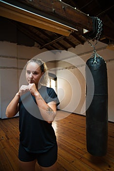 Portrait of young woman in combative position