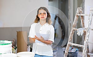 Portrait of young woman construciton inspector with documents