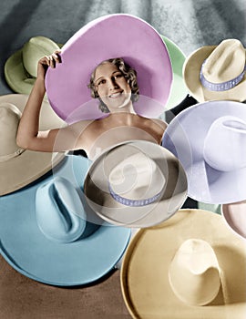 Portrait of a young woman covered with hats photo