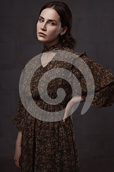 Portrait of a young woman with curly hair in a dark key