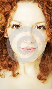 Portrait of young woman with curly red hair