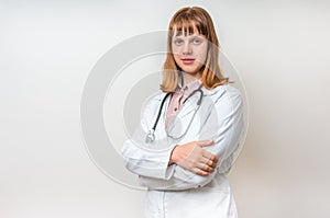 Portrait of young woman doctor with arms crossed