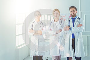 Portrait of young woman doctor with white coat standing in hospital