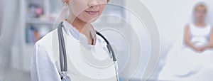 Portrait of young woman doctor with white coat standing in hospital