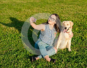 Portrait of young woman doing selfie with her dog