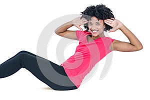 Portrait of young woman doing sit ups