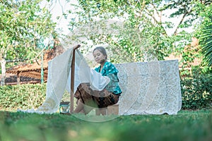 Portrait young woman drawing batik