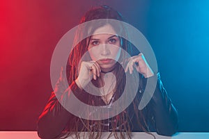 Portrait of young woman with dreadlocks over the dark background