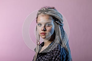 Portrait of a young woman with dreadlocks and piercings. photo