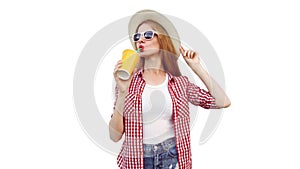 Portrait of young woman drinking fresh juice wearing summer straw hat, checkered shirt  on white background