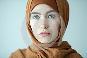 portrait of a young woman eastern type in the modern Muslim clothes and beautiful headdress