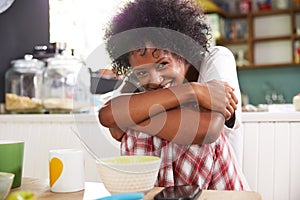 Portrait Of Young Woman Eating Breakfast In Kitchen