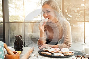 Portrait of young woman eating cookie heart