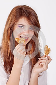 Portrait of young woman eating cookie