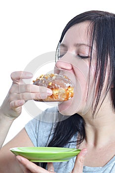 Portrait of a young woman eating a donut photo