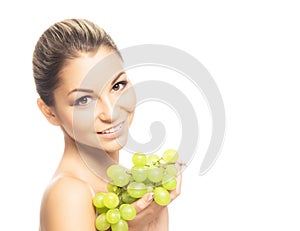 Portrait of a young woman eating fresh and tasty grapes