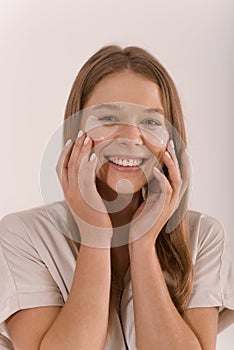 Portrait of a young woman with with a eyepatch on her face.