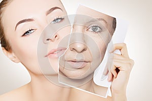 Portrait of young woman face holding portrait with old wrinkled