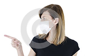 Portrait of young woman with face mask pointing side on copy space,