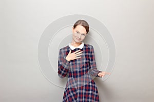 Portrait of young woman feeling respect and expressing gratitude