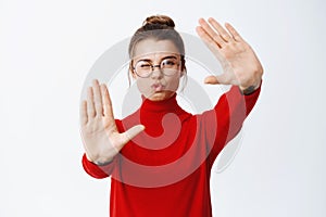 Portrait of young woman in glasses pucker lips and make hand camera frames gesture, capturing moment, standing over