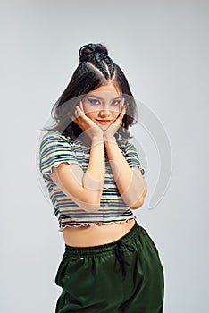 Portrait of young woman on grey background