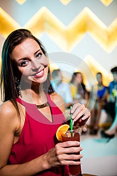 Portrait of young woman having a cocktail