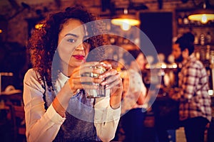 Portrait of young woman having a cocktail drink