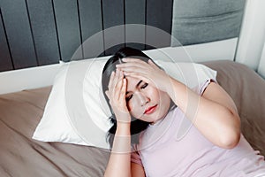 Portrait of Young Woman Having Depression suffering With Headache From Insomnia on Her Bedroom., Healthcare and Medicine Concept