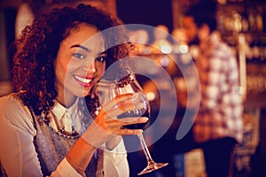 Portrait of young woman having red wine