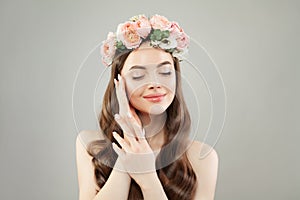 Portrait of young woman with healthy skin and hair wearing flowers wreath