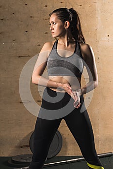 Portrait of young woman with her hands on hips